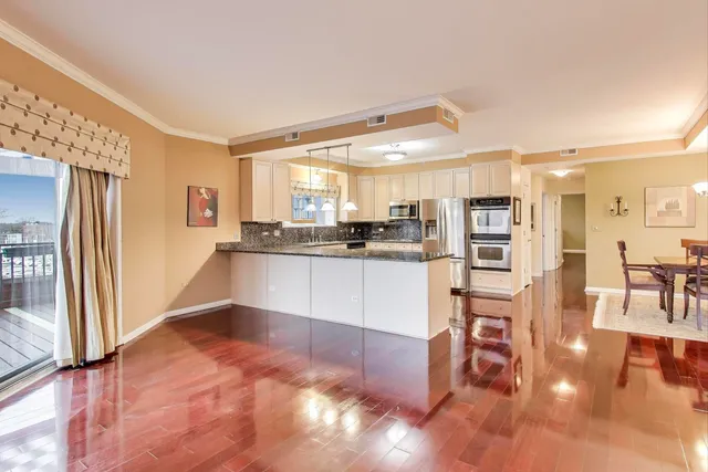 a kitchen with stainless steel appliances granite countertop a refrigerator and a stove top oven