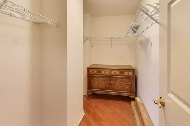 a view of walk in closet with clothes