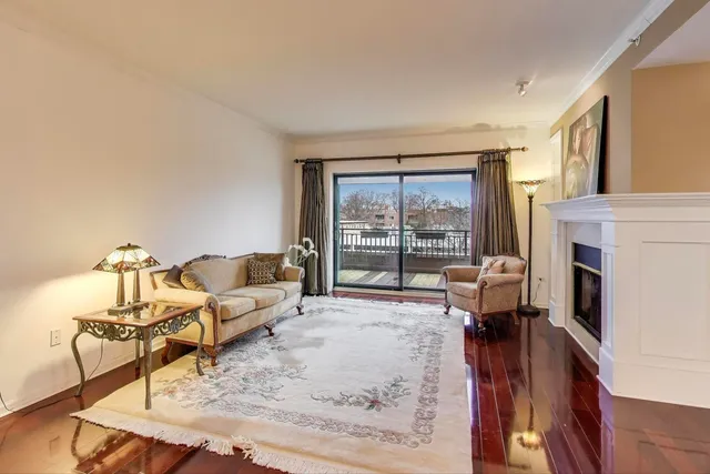 a living room with furniture large window and a table