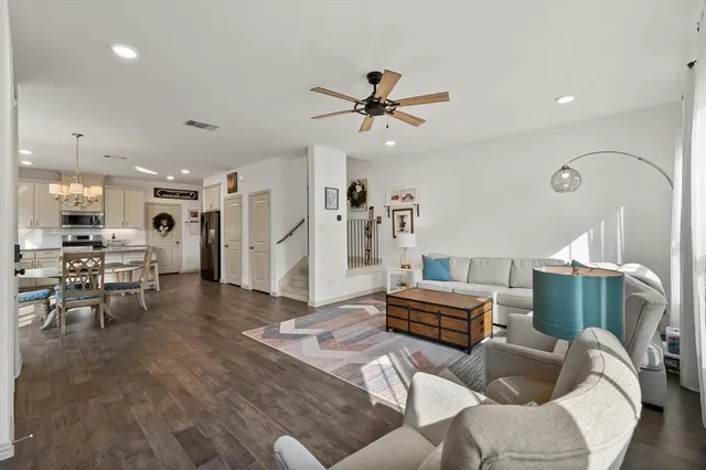 a living room with furniture and kitchen view