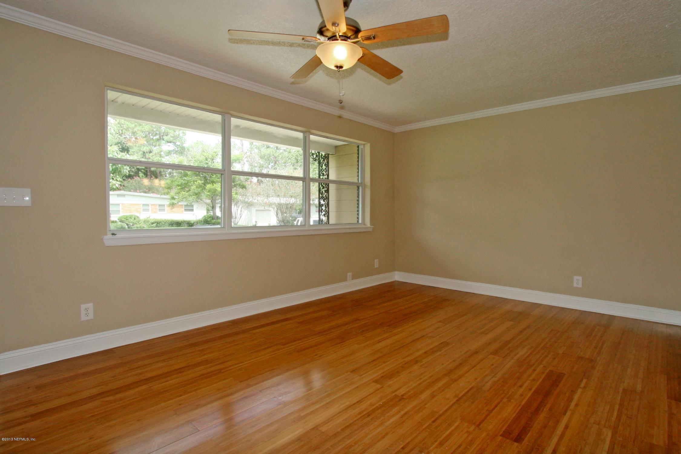 6814 Provost Road North Jacksonville, FL 32216 - Photo 5 of 17 a view of an empty room with wooden floor and a window