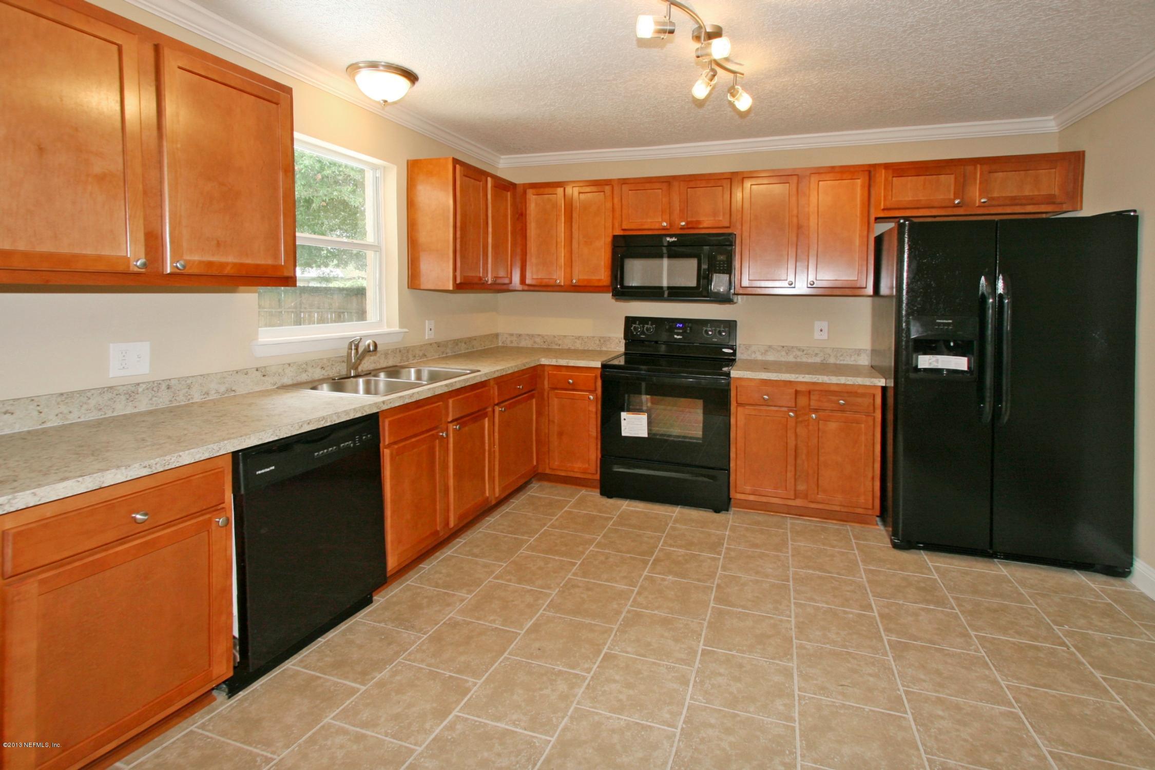 6814 Provost Road North Jacksonville, FL 32216 - Photo 7 of 17 a kitchen with stainless steel appliances granite countertop a refrigerator and a sink