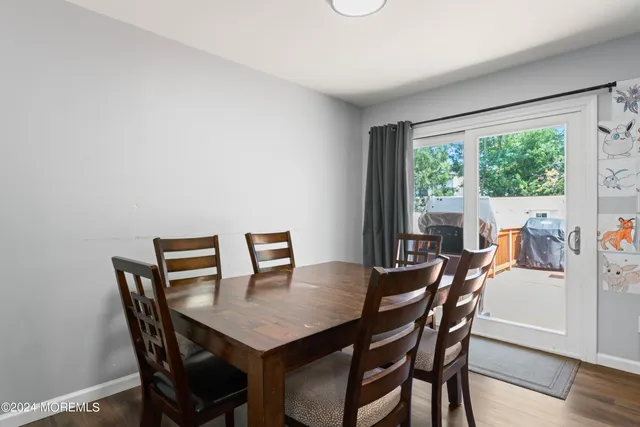 a view of a dining room with furniture and a potted plant
