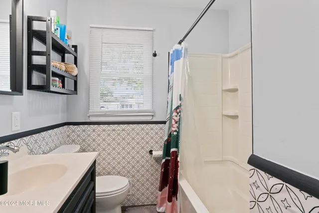 a bathroom with a sink a toilet and a bathtub