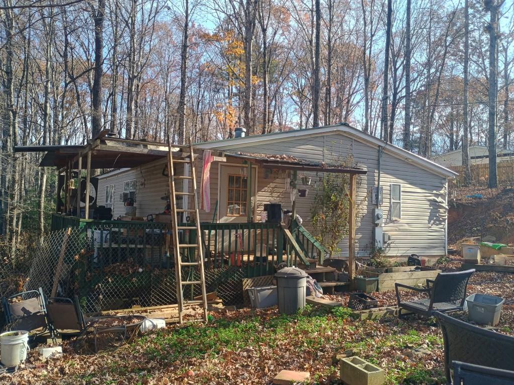 61 Lake Rd Court Ellijay, GA 30540 - Photo 3 of 14 a front view of a house with garden