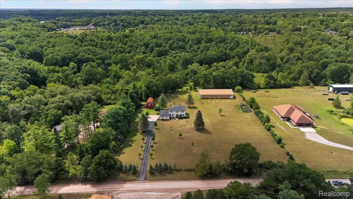 7330 West Gates Street Romeo, MI 48065 - Photo 60 of 73 Expansive property featuring a private paved driveway, mature trees, open green spaces, and multiple structures including a primary residence and additional outbuildings