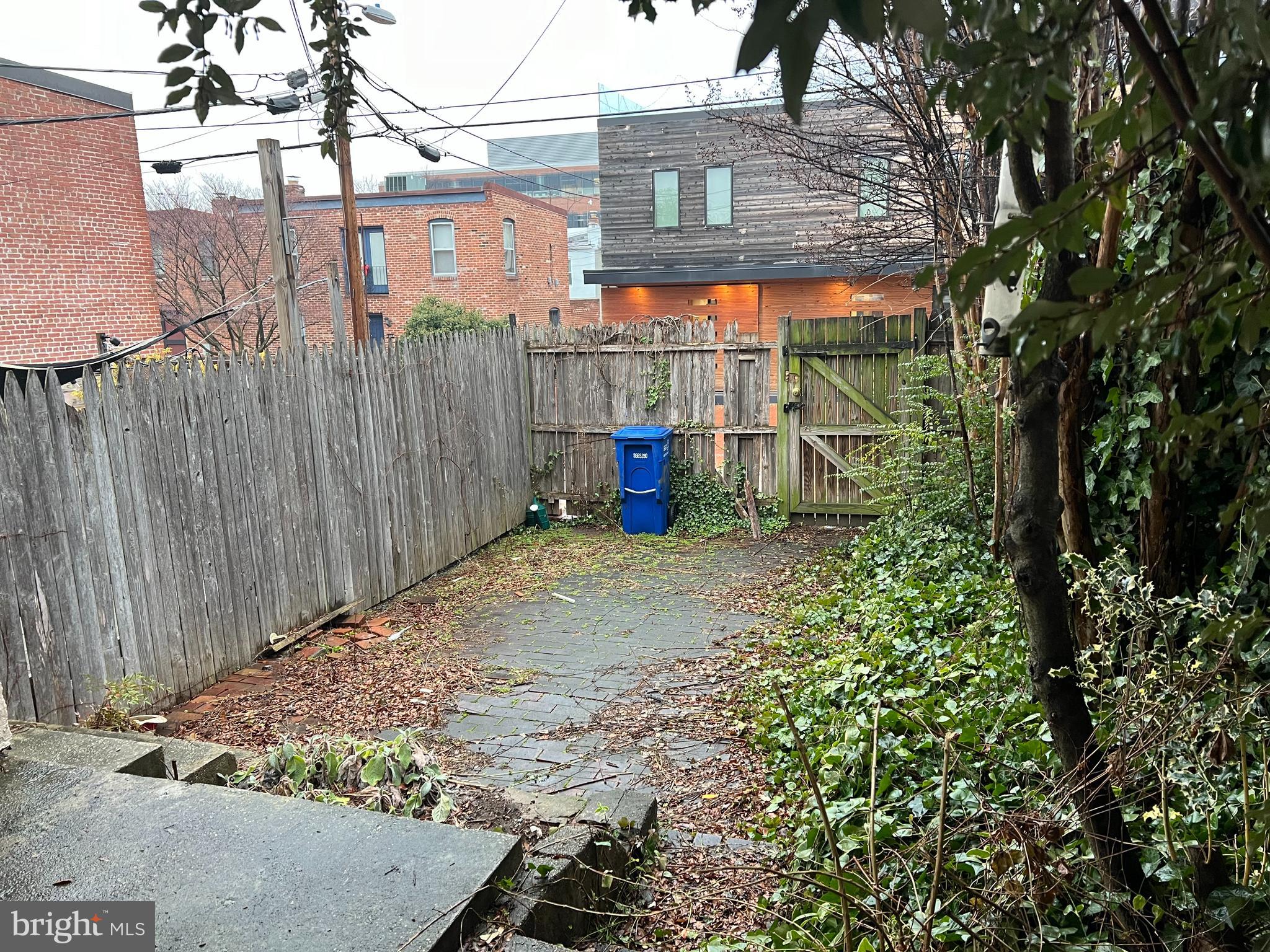 422 11th Street Southeast Washington, DC 20003 - Photo 12 of 24 a view of a backyard with large trees and wooden fence