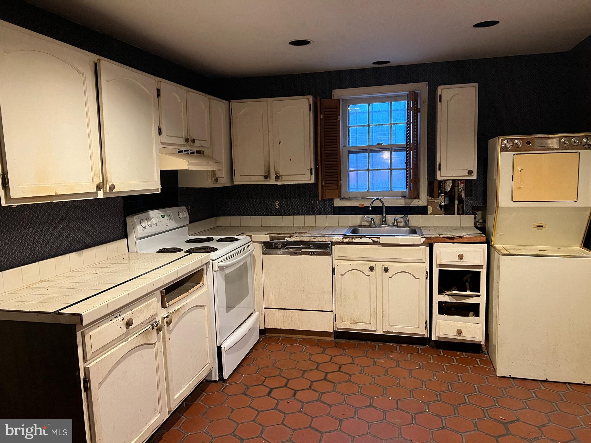 422 11th Street Southeast Washington, DC 20003 - Photo 9 of 24 a kitchen with white cabinets and white appliances
