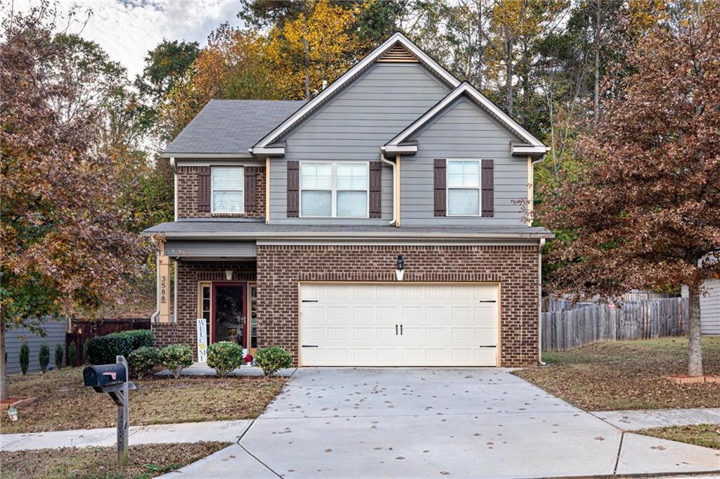 3588 Sycamore Bend Decatur, GA 30034 - Photo 1 of 1 a front view of a house with a yard and garage