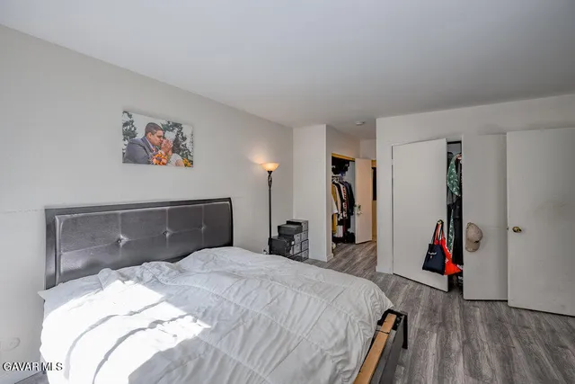 a bedroom with a bed and a closet