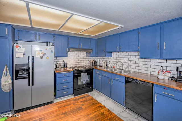 a kitchen with granite countertop stainless steel appliances and wooden cabinets
