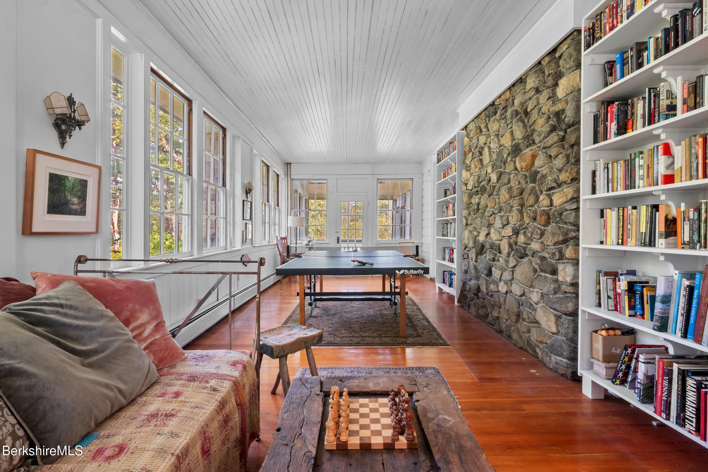 535 Main Road Monterey, MA 01245 - Photo 13 of 45 a living room with a couch and a book shelf