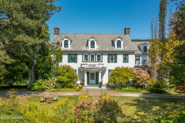 a bedroom with a bed and a bookshelf