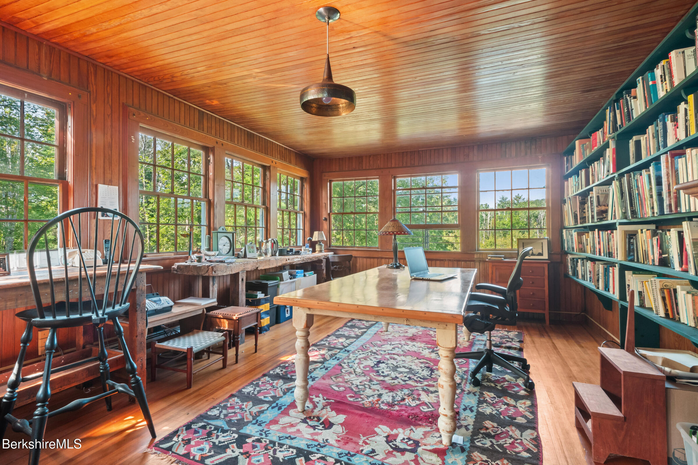 535 Main Road Monterey, MA 01245 - Photo 32 of 45 a living room with furniture a bookshelf and a large window