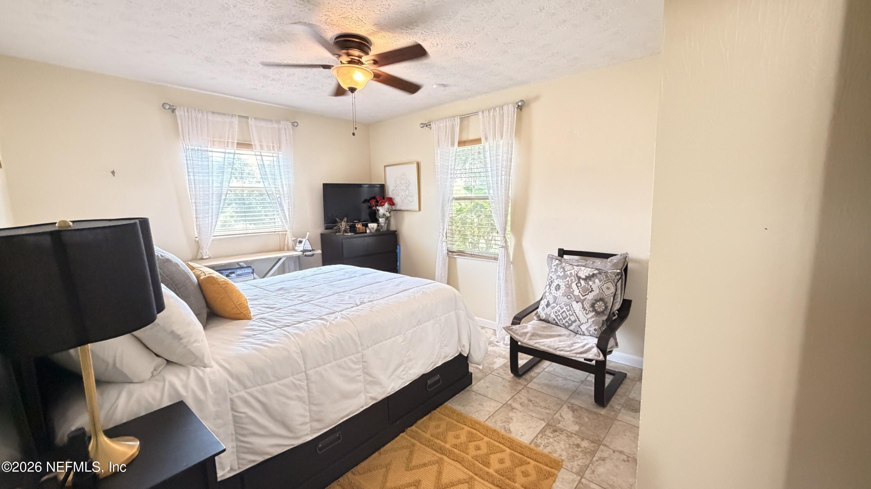 1302 Fort Meade Road Frostproof, FL 33843 - Photo 32 of 39 a bedroom with a bed and wooden floor