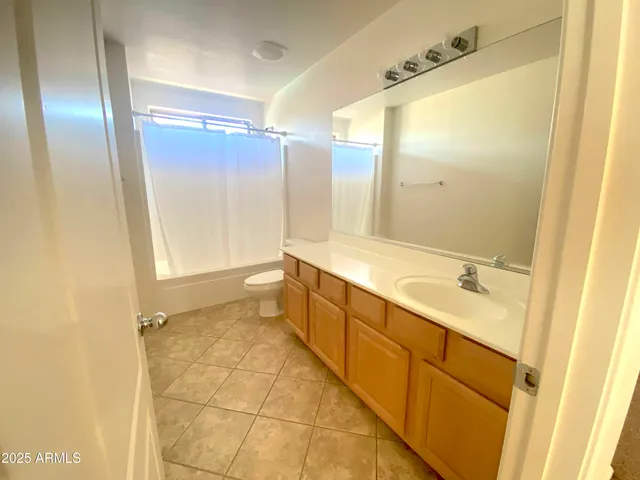 a bathroom with a sink toilet and mirror
