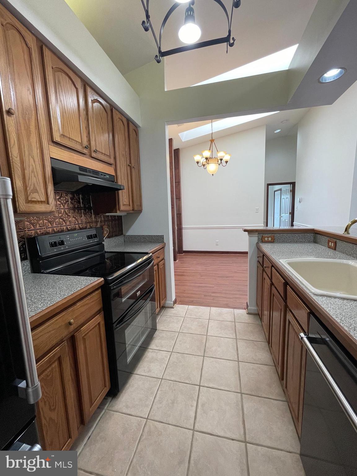 13701 Modrad Way, Unit 9C34 Silver Spring, MD 20904 - Photo 11 of 26 a kitchen with a sink a stove and cabinets
