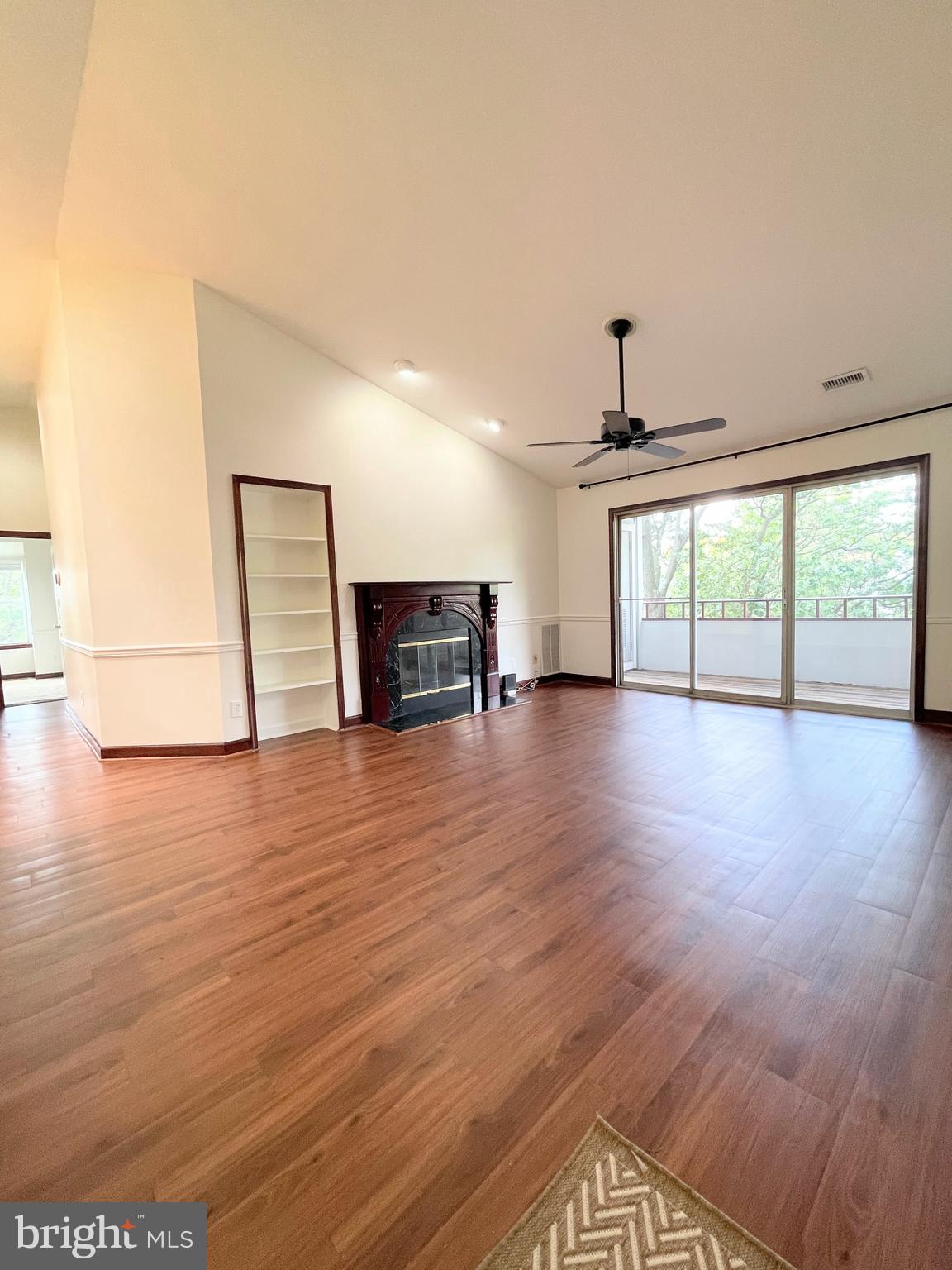 13701 Modrad Way, Unit 9C34 Silver Spring, MD 20904 - Photo 2 of 26 a view of empty room with wooden floor and fan