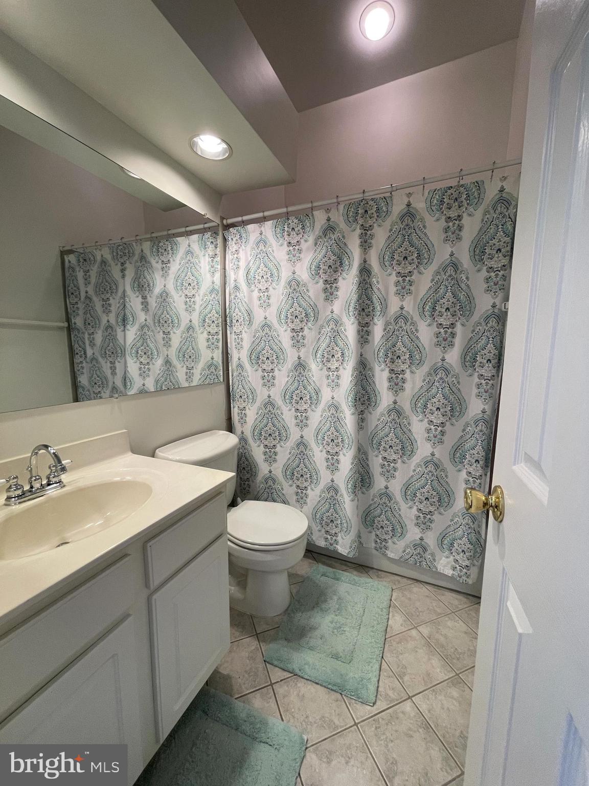 13701 Modrad Way, Unit 9C34 Silver Spring, MD 20904 - Photo 21 of 26 a bathroom with a granite countertop sink and a mirror