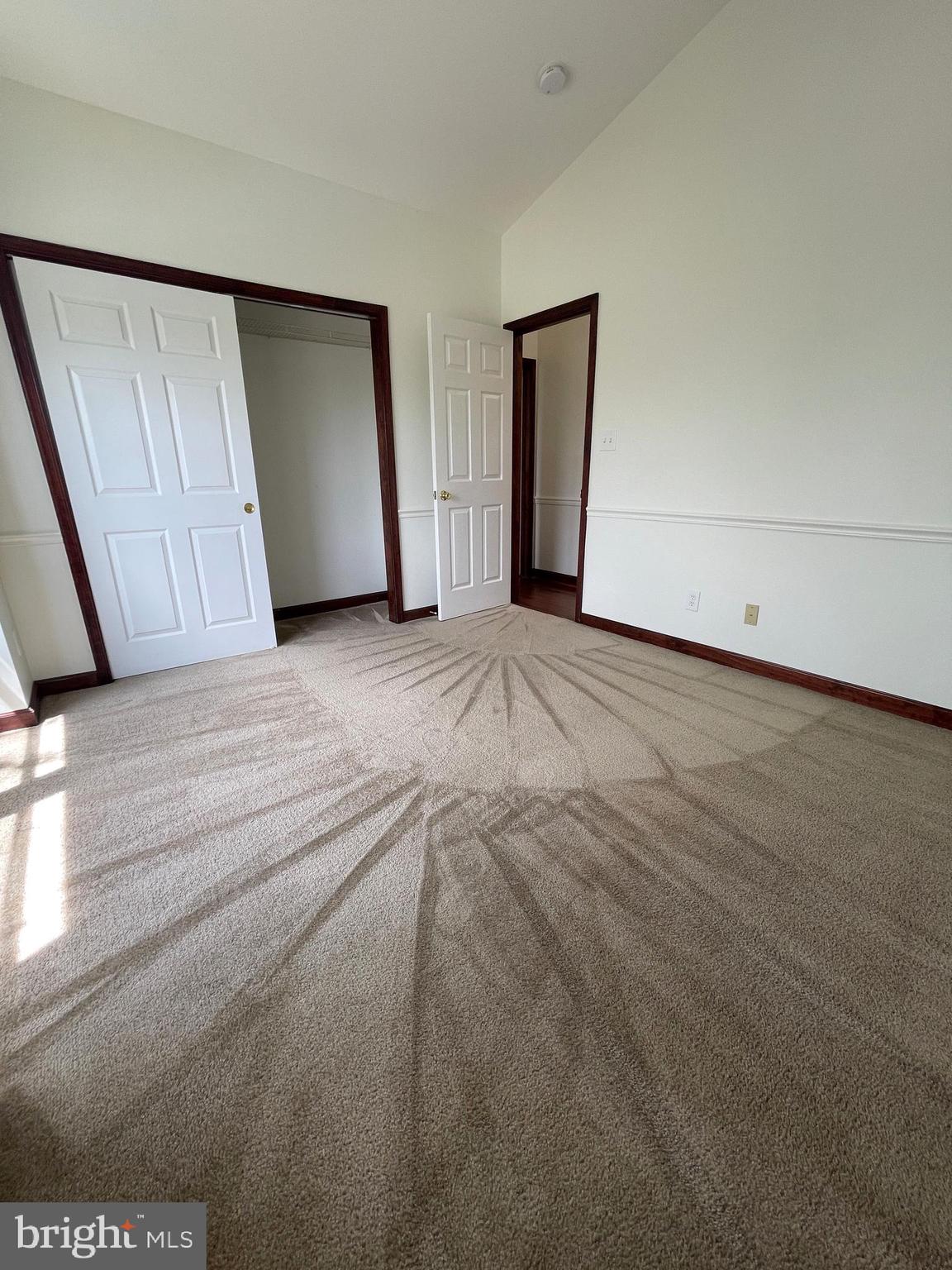 13701 Modrad Way, Unit 9C34 Silver Spring, MD 20904 - Photo 22 of 26 a view of an empty room with wooden floor and closet