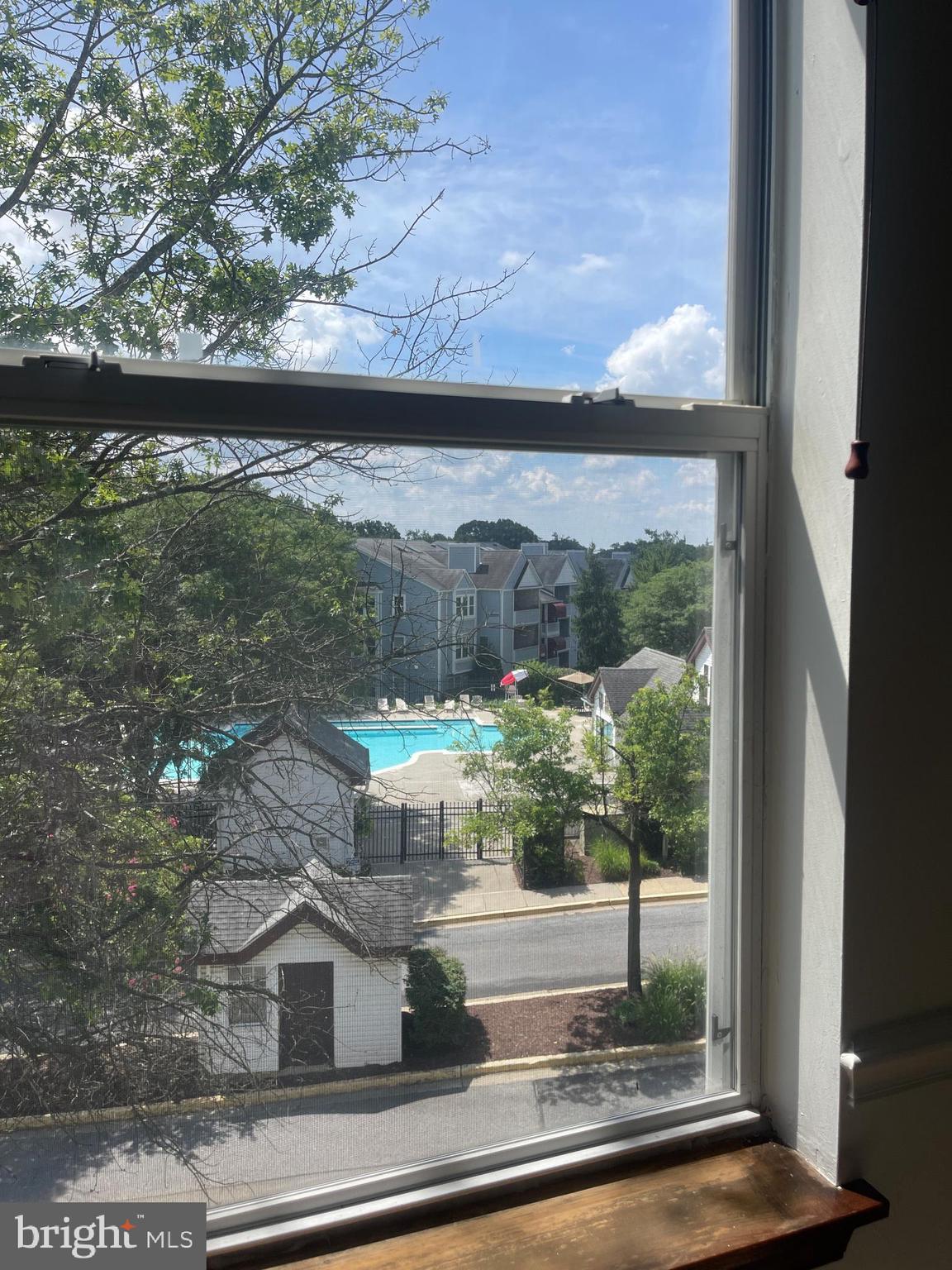13701 Modrad Way, Unit 9C34 Silver Spring, MD 20904 - Photo 25 of 26 a view of a living room with a floor to ceiling window and wooden floor