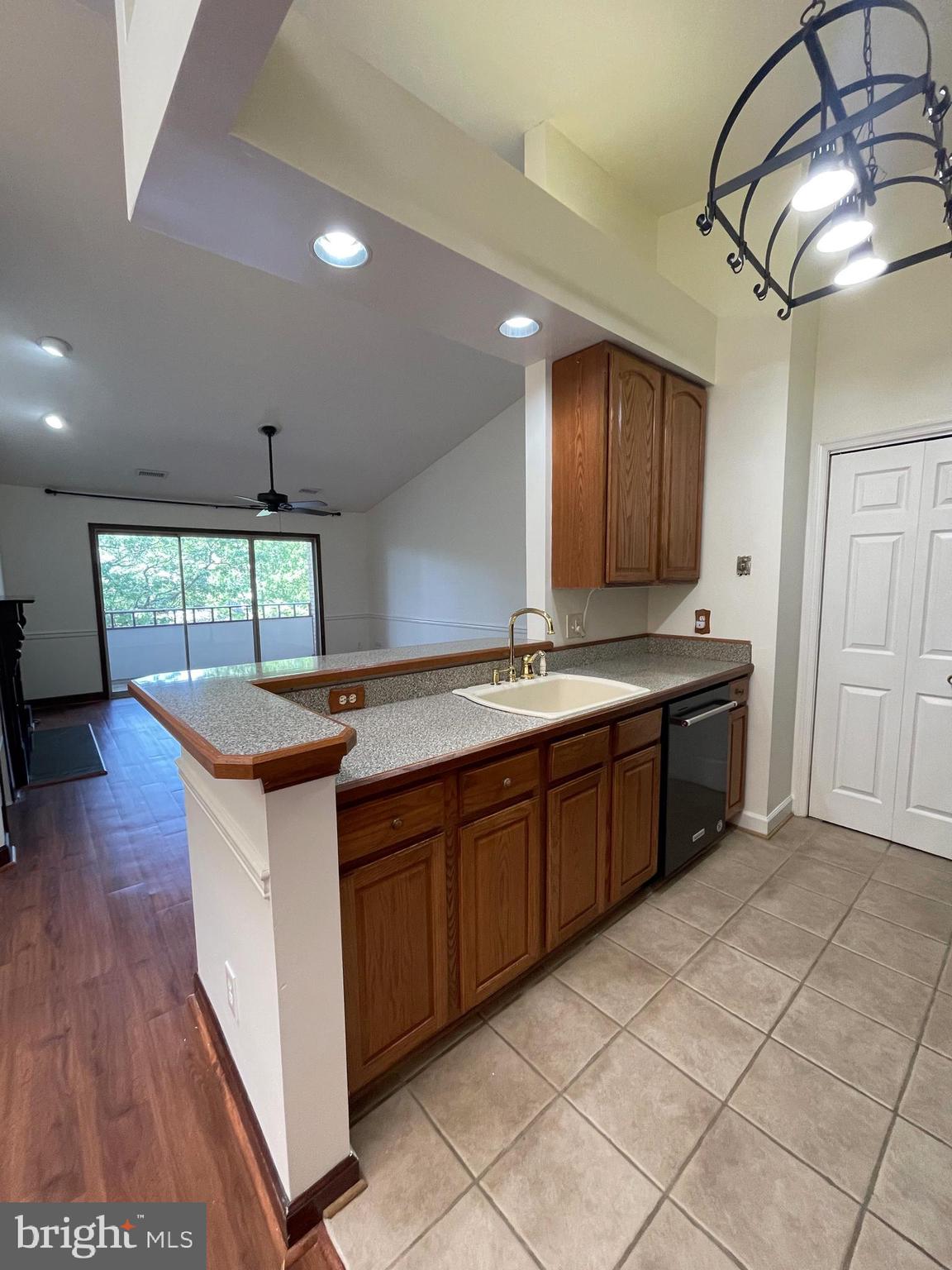 13701 Modrad Way, Unit 9C34 Silver Spring, MD 20904 - Photo 5 of 26 a kitchen with stainless steel appliances granite countertop a sink counter space cabinets and wooden floor