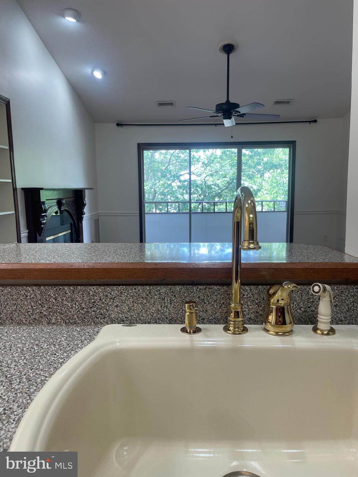 13701 Modrad Way, Unit 9C34 Silver Spring, MD 20904 - Photo 6 of 26 a bathroom with a granite countertop sink and mirror