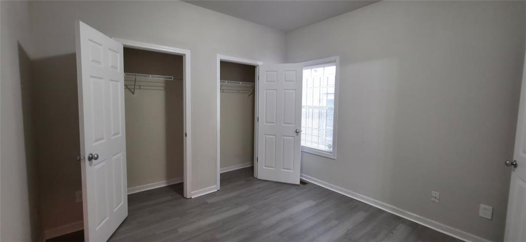 162 Walnut Street Southwest Atlanta, GA 30314 - Photo 13 of 18 an empty room with wooden floor and windows