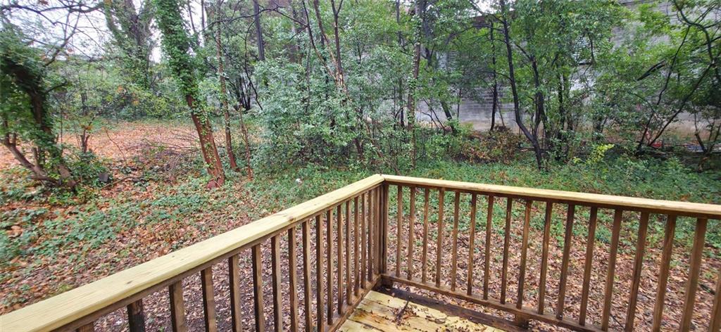 162 Walnut Street Southwest Atlanta, GA 30314 - Photo 17 of 18 a balcony with trees in front of it