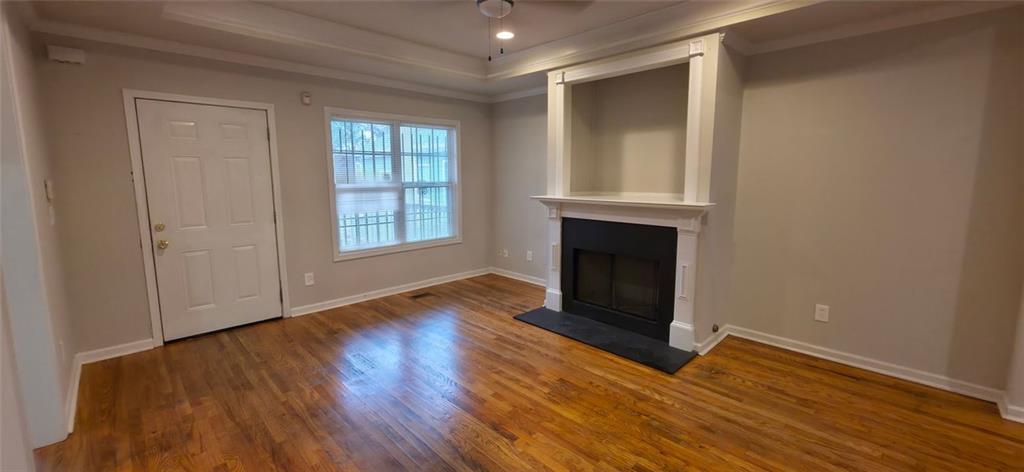162 Walnut Street Southwest Atlanta, GA 30314 - Photo 2 of 18 a view of an empty room with wooden floor and a window