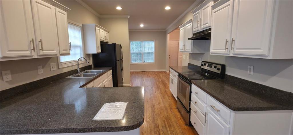 162 Walnut Street Southwest Atlanta, GA 30314 - Photo 4 of 18 a kitchen with stainless steel appliances granite countertop a stove a sink and a refrigerator