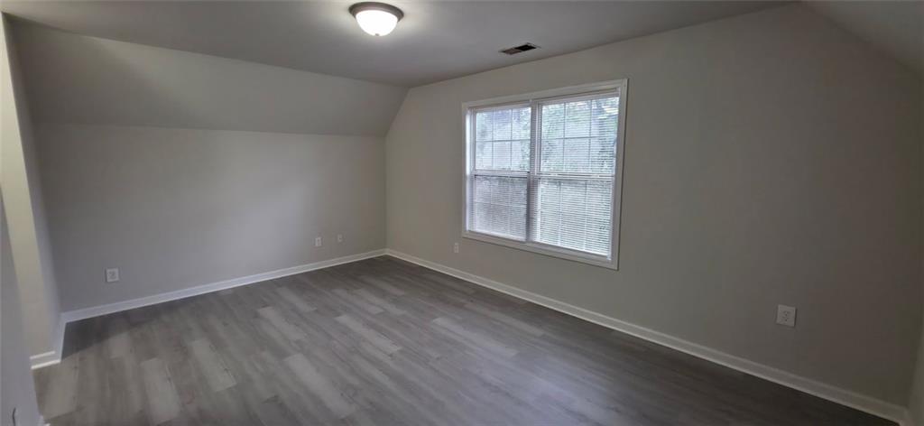 162 Walnut Street Southwest Atlanta, GA 30314 - Photo 5 of 18 an empty room with wooden floor and windows