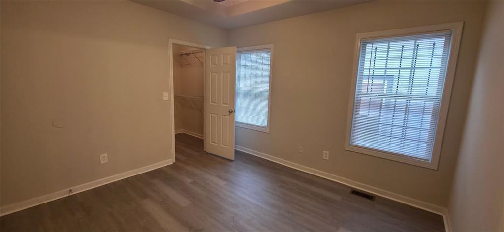 162 Walnut Street Southwest Atlanta, GA 30314 - Photo 6 of 18 an empty room with wooden floor and windows