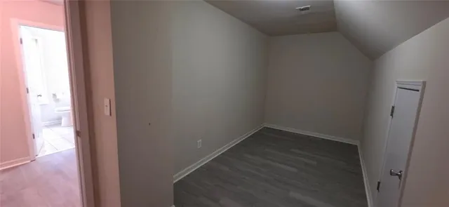a view of hallway with wooden floor