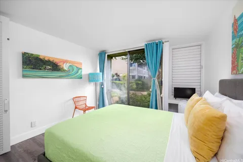 a bedroom with a bed and a chair