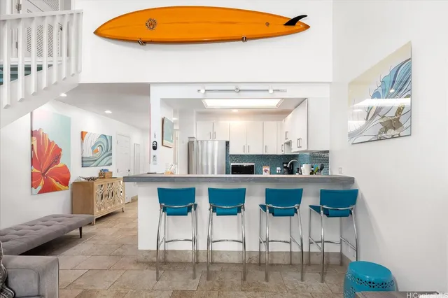a kitchen with stainless steel appliances kitchen island granite countertop a table and chairs