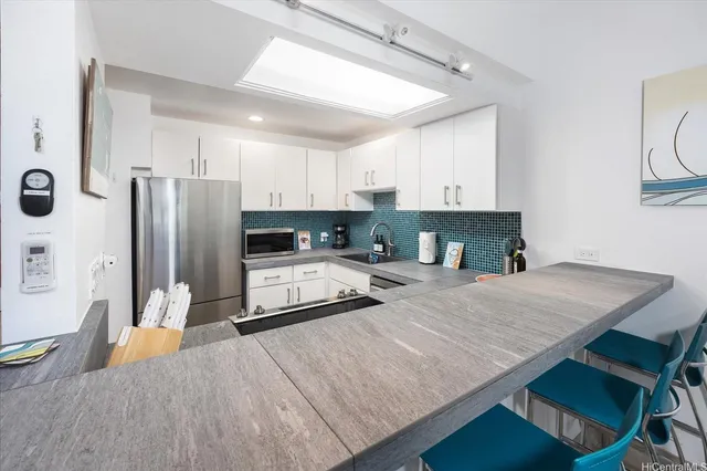 a kitchen with stainless steel appliances a refrigerator sink and stove