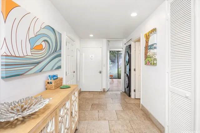 a bedroom with a bed and a painting on the wall