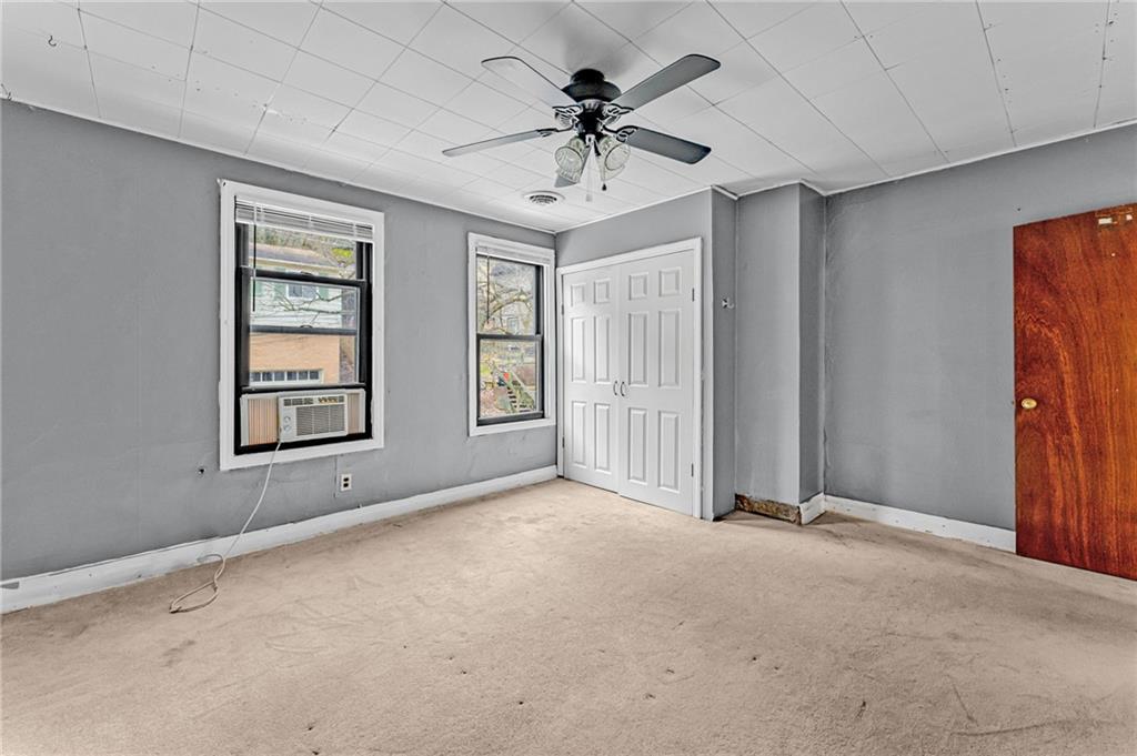 16 Spring Street Etna, PA 15223 - Photo 11 of 21 an empty room with windows and ceiling fan