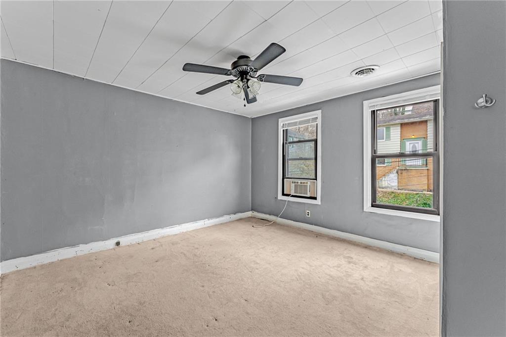 16 Spring Street Etna, PA 15223 - Photo 12 of 21 an empty room with windows and fan