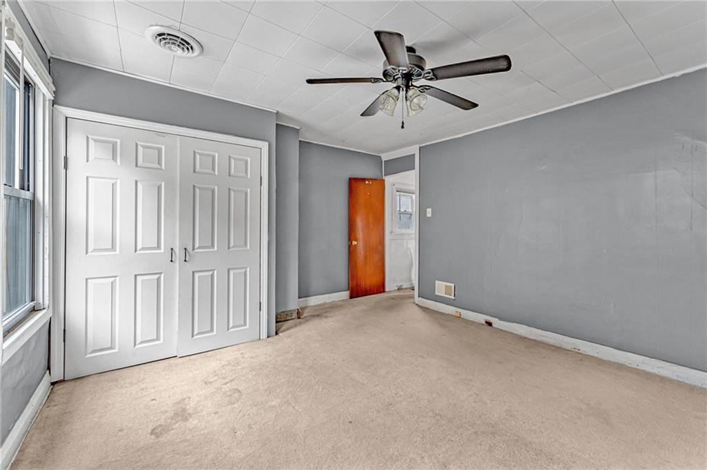 16 Spring Street Etna, PA 15223 - Photo 13 of 21 a view of a livingroom with a ceiling fan & windows