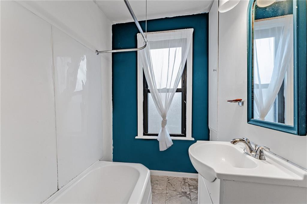 16 Spring Street Etna, PA 15223 - Photo 15 of 21 a bathroom with a sink a toilet and a mirror