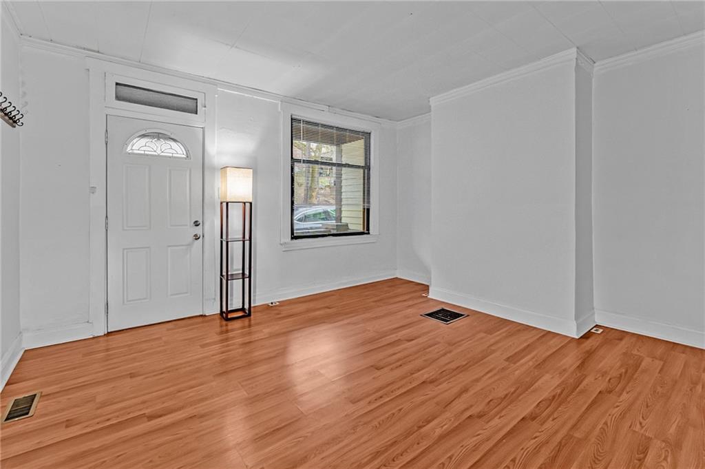 16 Spring Street Etna, PA 15223 - Photo 5 of 21 a view of empty room with wooden floor and fan