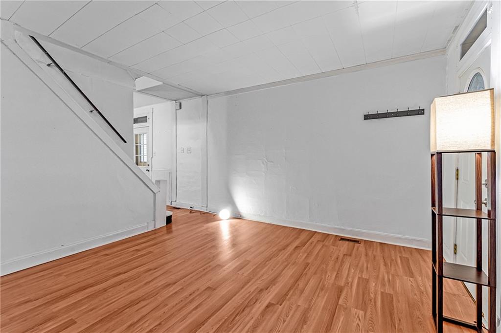 16 Spring Street Etna, PA 15223 - Photo 6 of 21 a view of an empty room with wooden floor and a window
