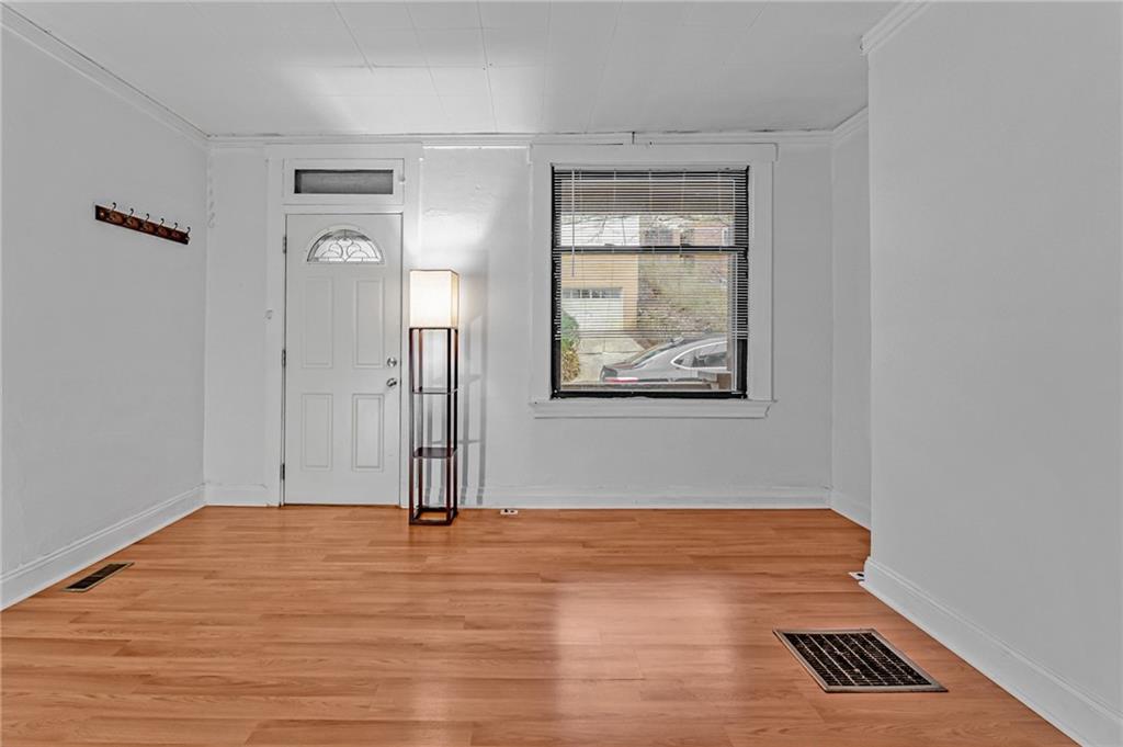 16 Spring Street Etna, PA 15223 - Photo 7 of 21 an empty room with wooden floor cabinet and windows