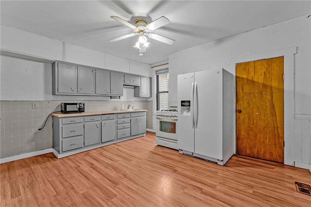 16 Spring Street Etna, PA 15223 - Photo 8 of 21 a kitchen with stainless steel appliances granite countertop a refrigerator sink and cabinets