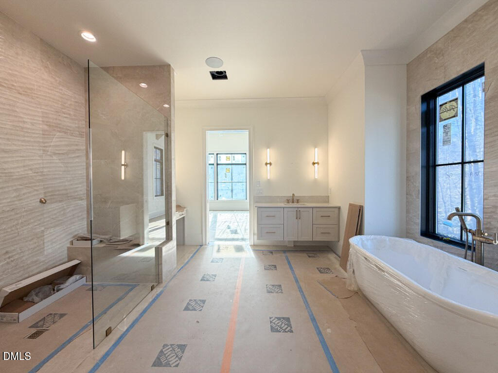 1513 Rock Dove Way Raleigh, NC 27614 - Photo 14 of 38 a bathroom with a tub a mirror and a shower