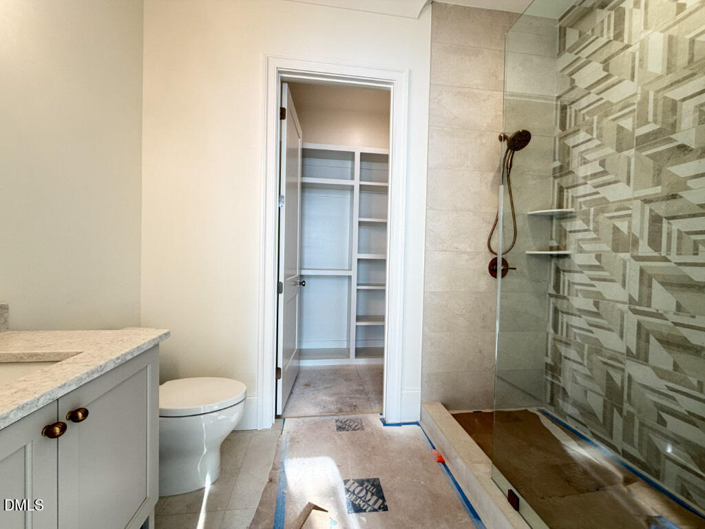 1513 Rock Dove Way Raleigh, NC 27614 - Photo 18 of 38 a bathroom with a granite countertop shower a toilet and a sink