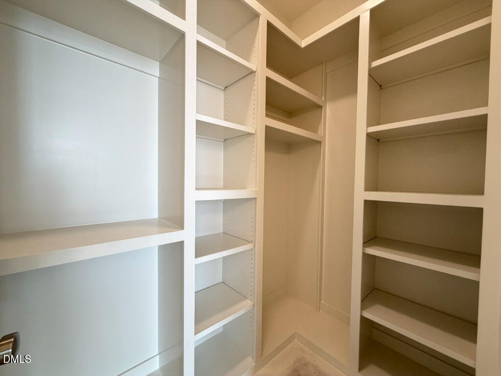1513 Rock Dove Way Raleigh, NC 27614 - Photo 19 of 38 a view of walk in closet with empty racks