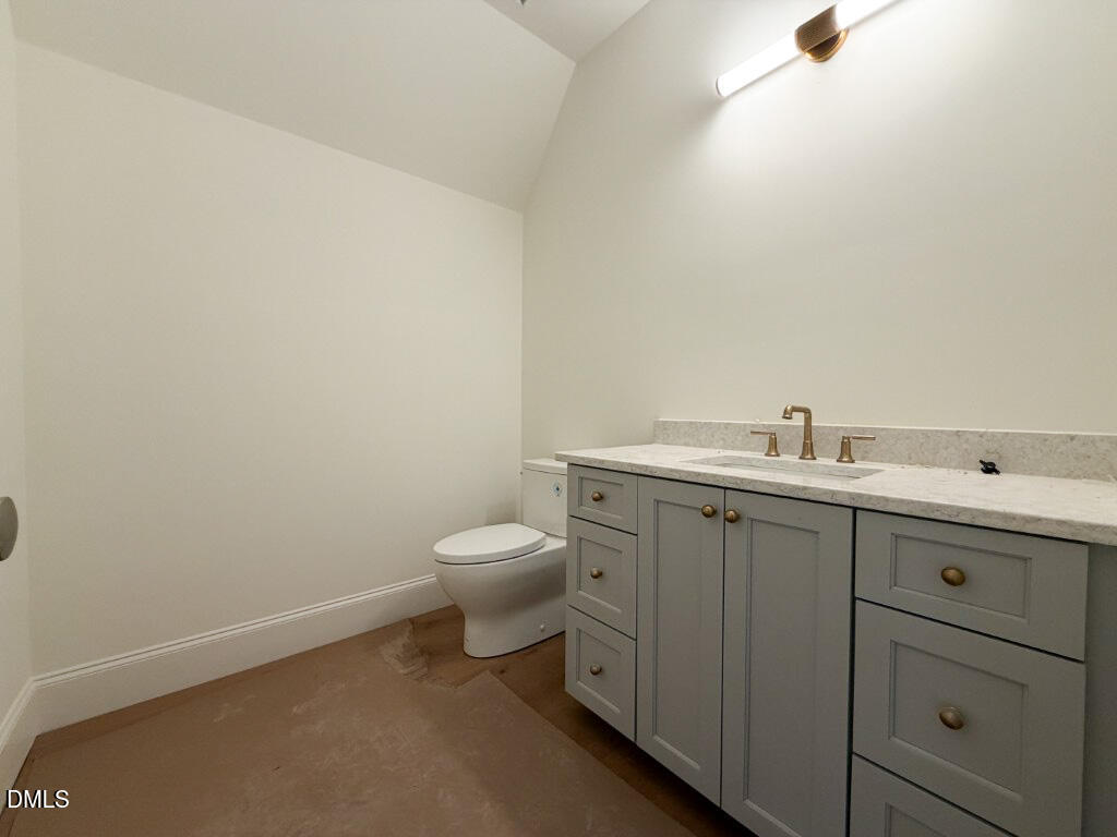 1513 Rock Dove Way Raleigh, NC 27614 - Photo 27 of 38 a bathroom with a granite countertop toilet and sink